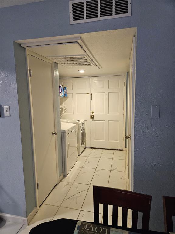 1823 East Grauwyler Road, Unit 198 Irving, TX 75061 - Photo 8 of 9 a view of a kitchen with white cabinets and wooden floor