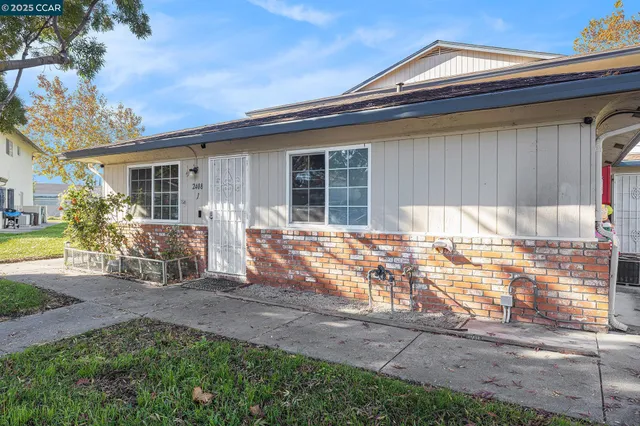a view of house with backyard and outdoor seating