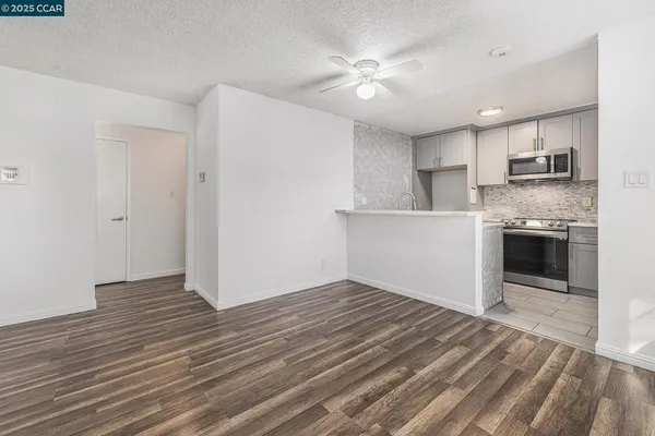 a kitchen with sink a microwave and refrigerator
