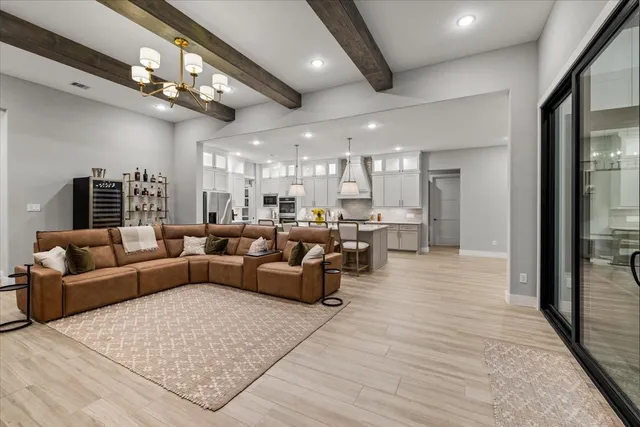 a kitchen with a stove a refrigerator a oven a sink and chairs