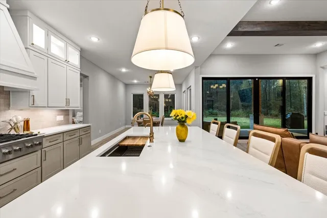 a kitchen with a refrigerator a stove and a wooden floor