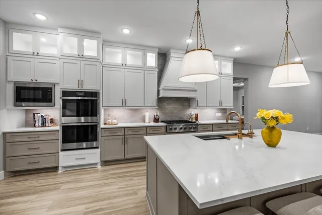 a dining room with furniture a chandelier and wooden floor