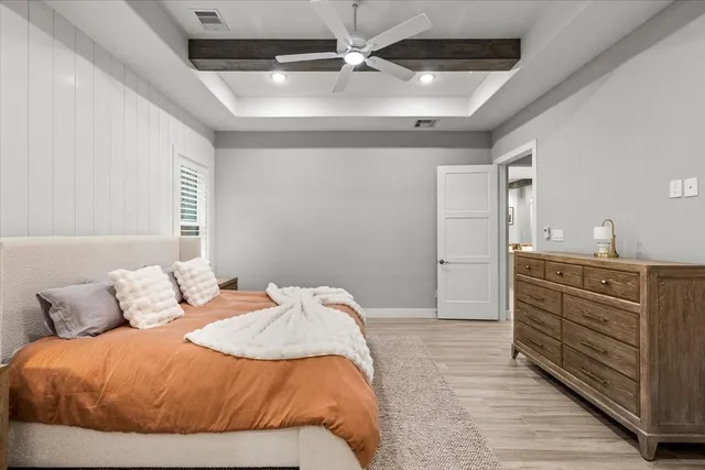 a spacious bathroom with a granite countertop sink and a mirror
