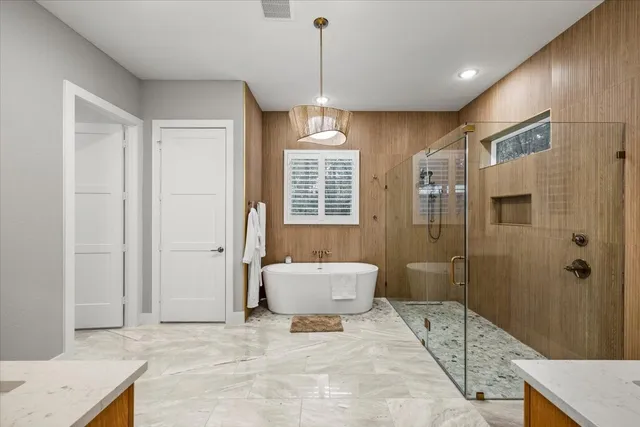 a spacious bathroom with a sink shower and a mirror