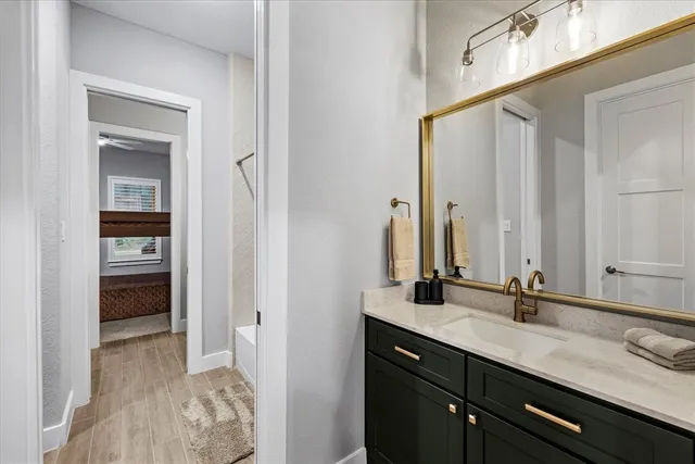 a en suite bathroom with a sink and a mirror