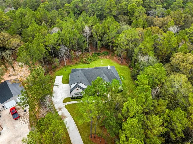 an aerial view of a house with a yard