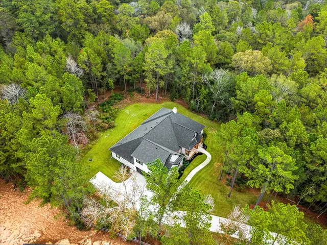 a view of a house with a yard and sitting area