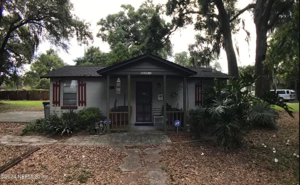 a view of a house with a backyard porch and sitting area