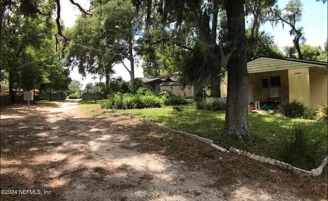a view of a park with large trees