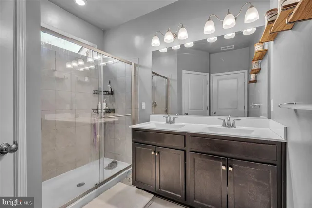 a bathroom with a sink double vanity and a mirror