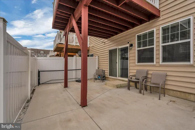 a view of a patio with table and chairs