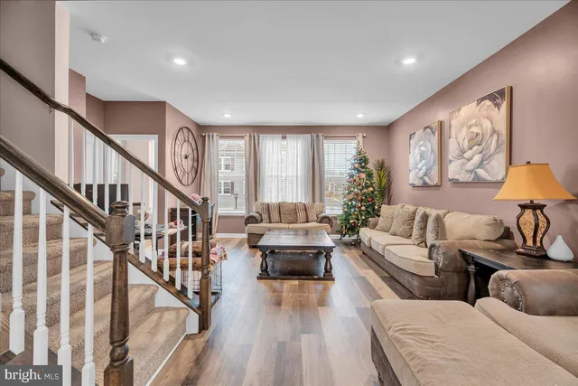 a living room with furniture and stairs