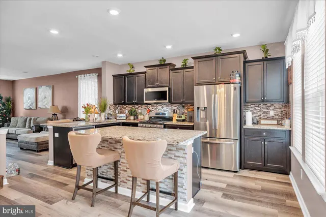 a kitchen with refrigerator cabinets and furniture