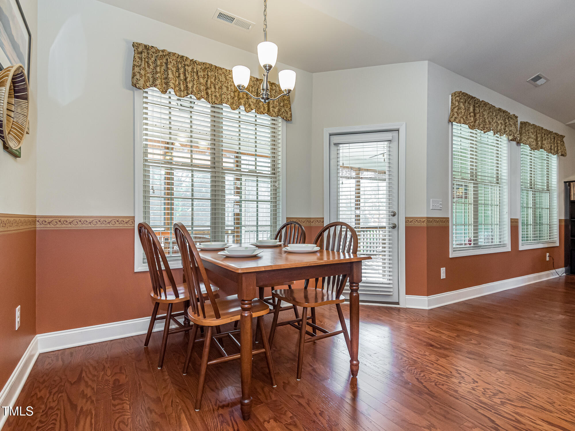 7512 Channery Way Raleigh, NC 27616 - Photo 13 of 45 a view of a dining room with furniture wooden floor and chandelier