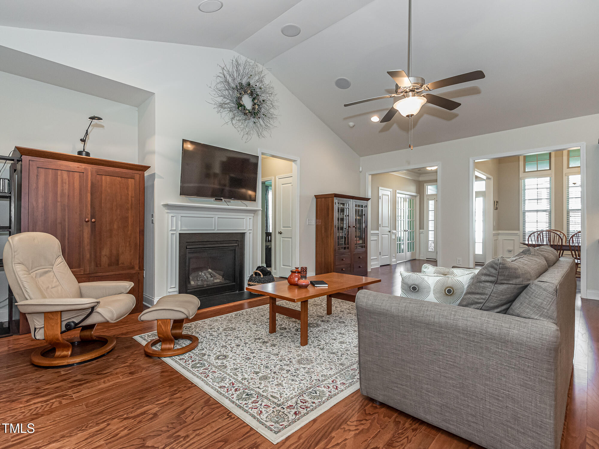 7512 Channery Way Raleigh, NC 27616 - Photo 16 of 45 a living room with furniture a flat screen tv and a fireplace