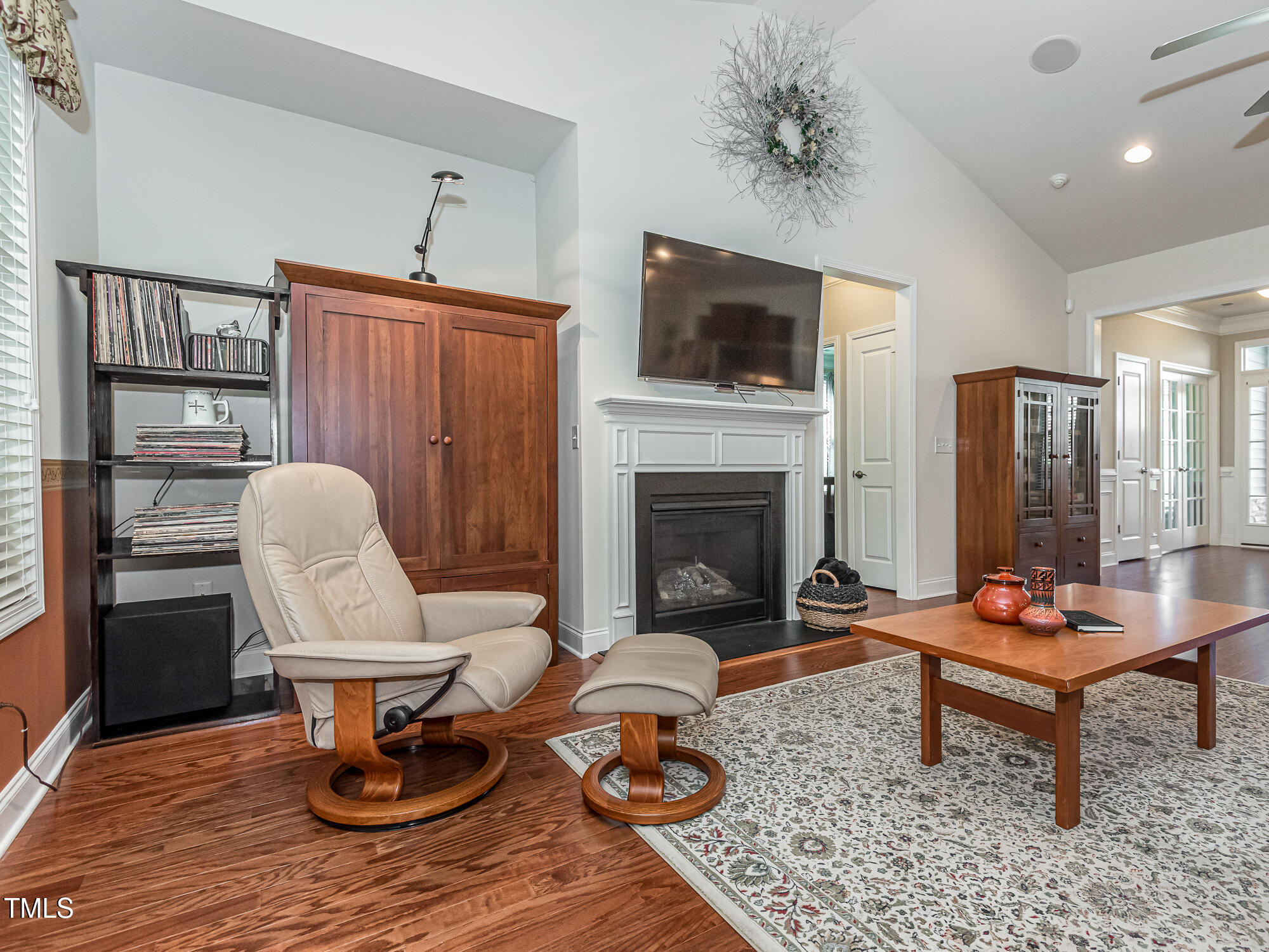 7512 Channery Way Raleigh, NC 27616 - Photo 17 of 45 a living room with furniture a flat screen tv and a fireplace