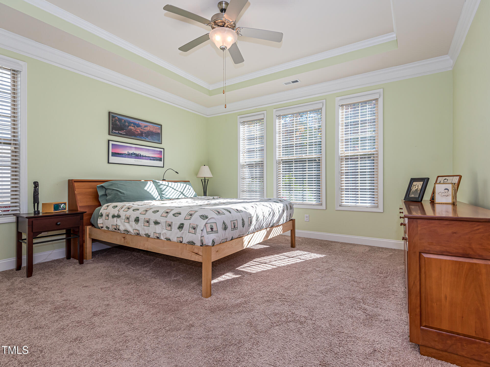 7512 Channery Way Raleigh, NC 27616 - Photo 18 of 45 a bedroom with a bed and a chandelier
