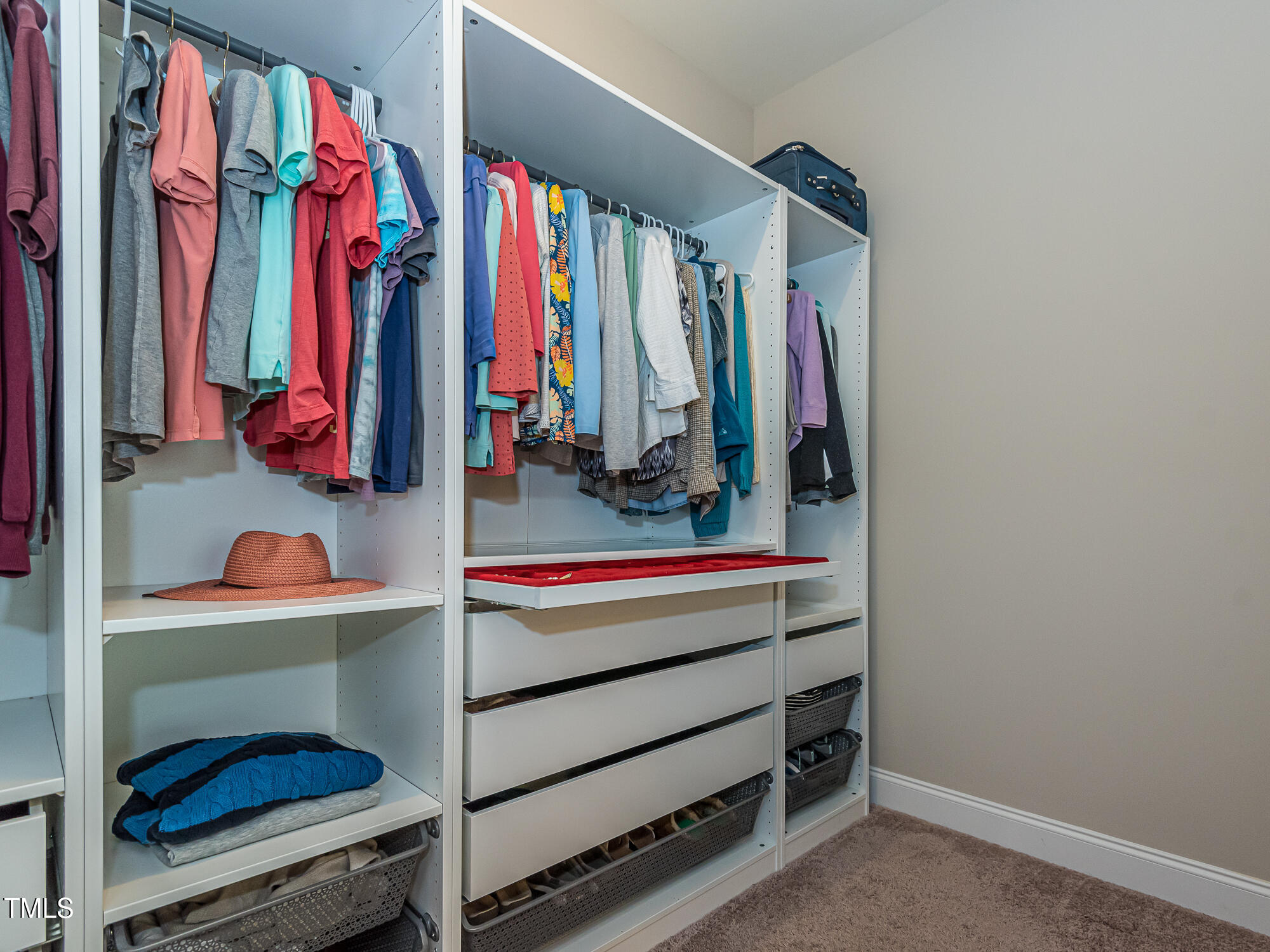 7512 Channery Way Raleigh, NC 27616 - Photo 23 of 45 a view of walk in closet with clothes and shoes