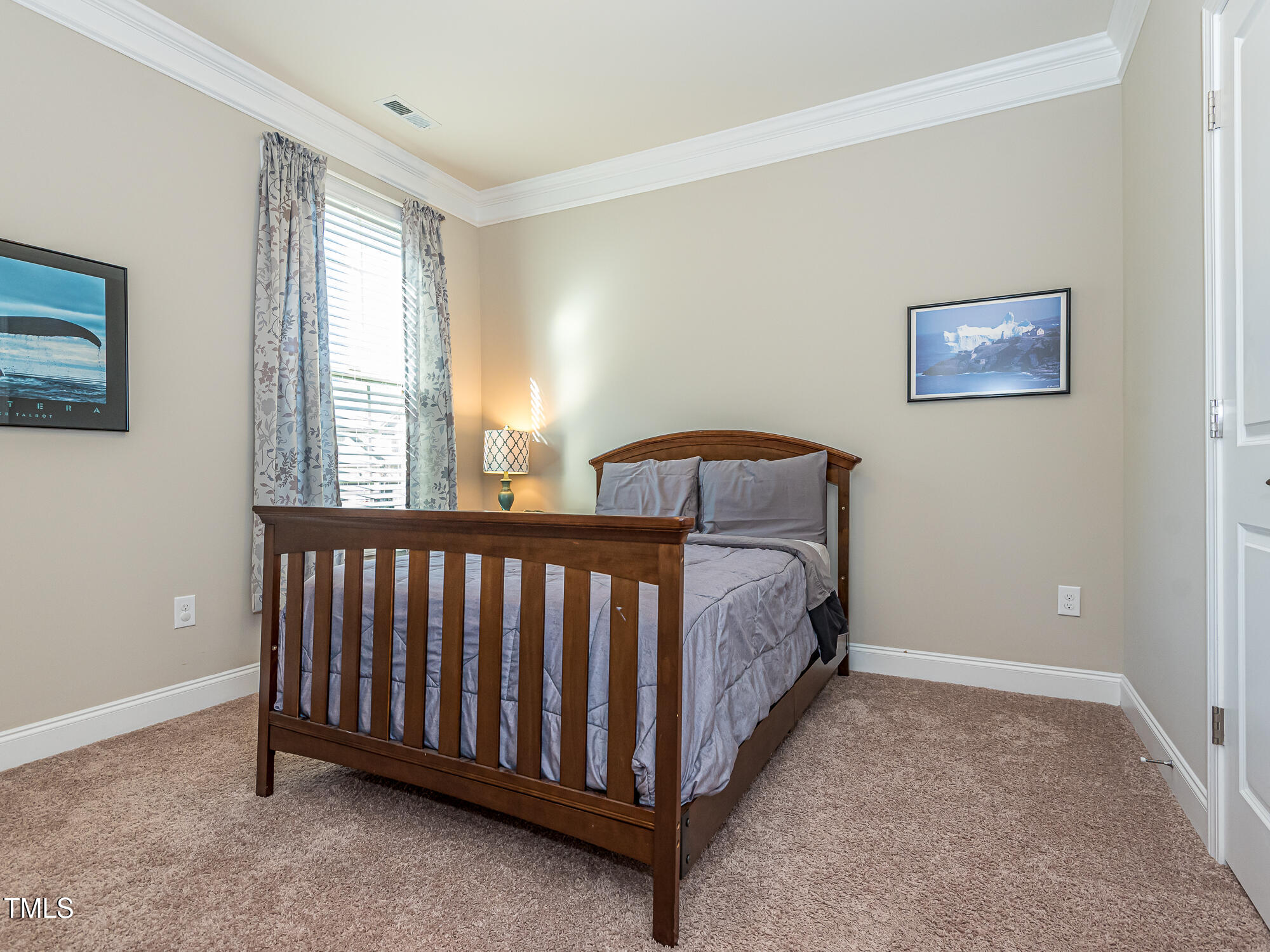 7512 Channery Way Raleigh, NC 27616 - Photo 25 of 45 a spacious bedroom with a bed and a window