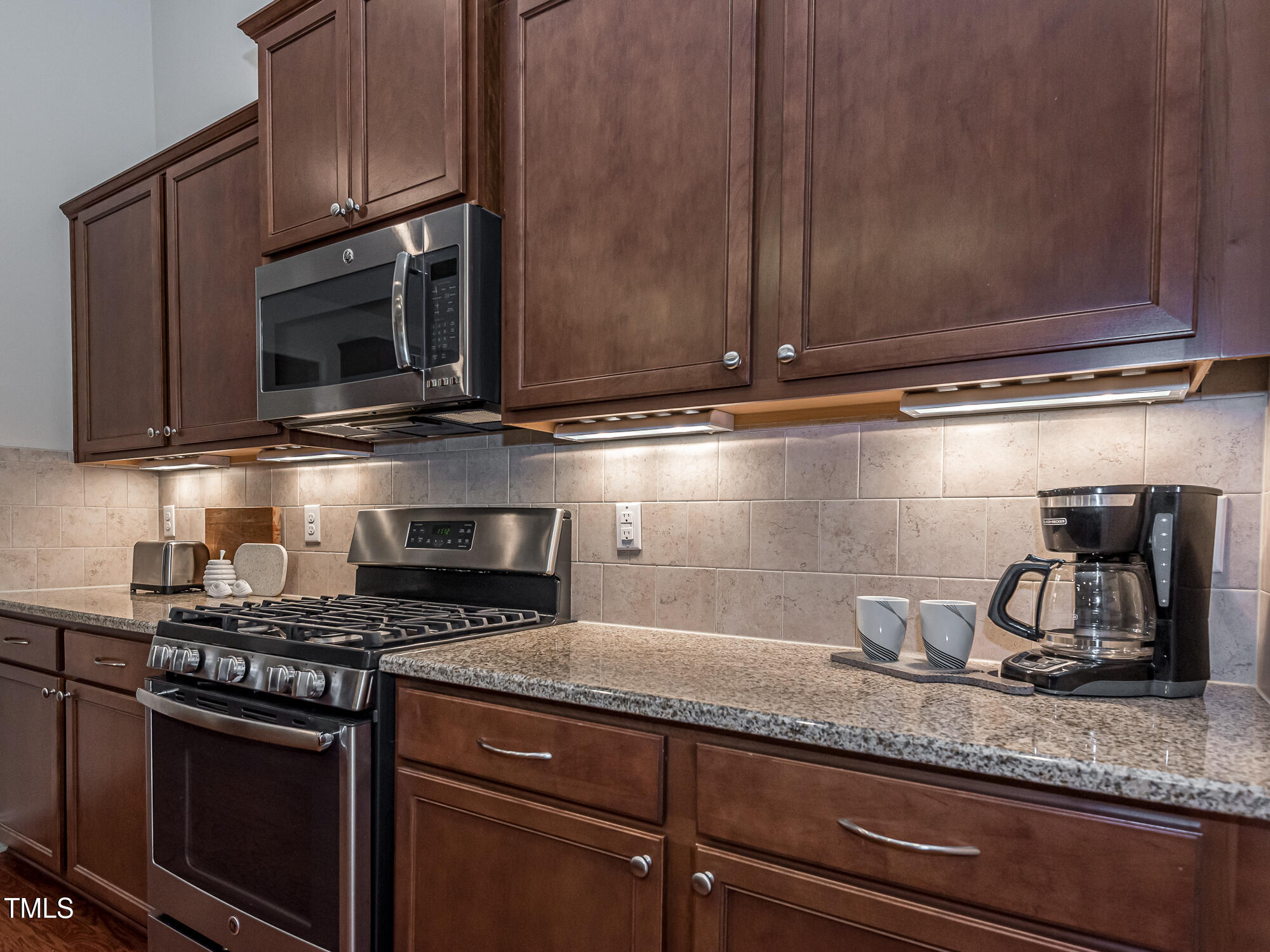 7512 Channery Way Raleigh, NC 27616 - Photo 5 of 45 a kitchen with granite countertop stainless steel appliances a sink and cabinets