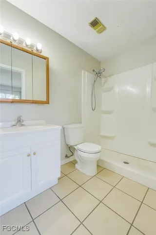 a bathroom with a toilet sink and shower