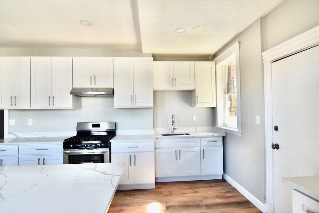 105 Homestead Street, Unit 2 Boston, MA 02121 - Photo 4 of 19 a kitchen with a sink a stove and cabinets