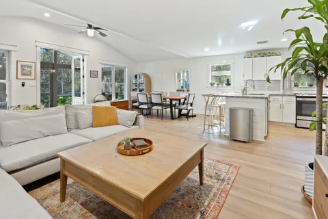 a living room with furniture and wooden floor