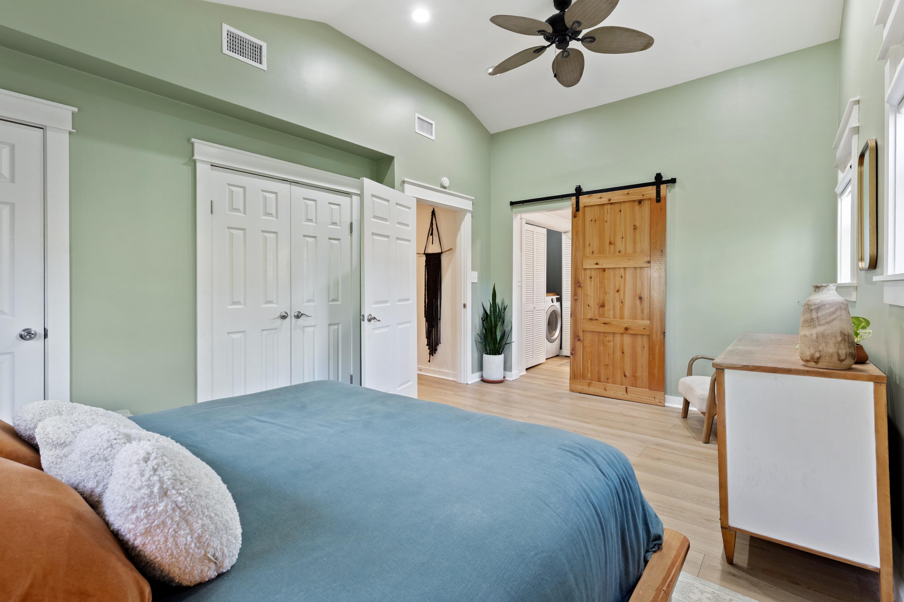 59 Chelsey Lane Santa Rosa Beach, FL 32459 - Photo 16 of 41 a bedroom with a bed and a chandelier