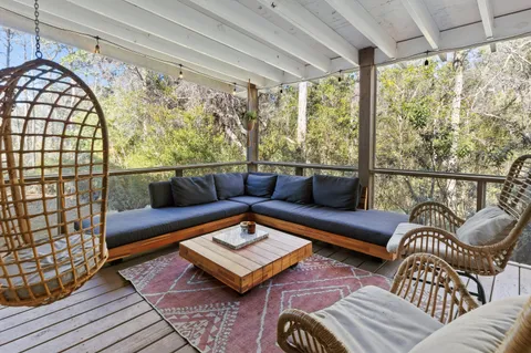 a sitting area with furniture and wooden floor