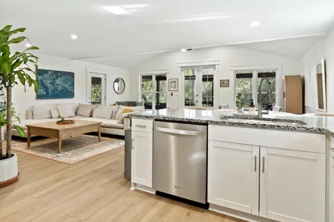 a living room with kitchen island furniture and a large window