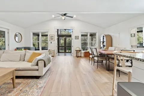 a living room with furniture and wooden floor