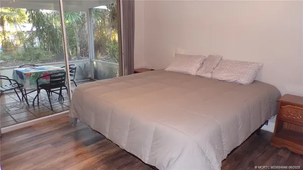 a large bed sitting in a bedroom next to a window