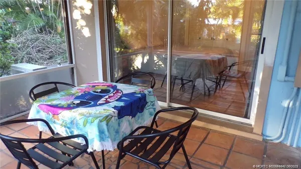 a dining room with furniture and window