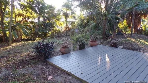 a view of a backyard with sitting area