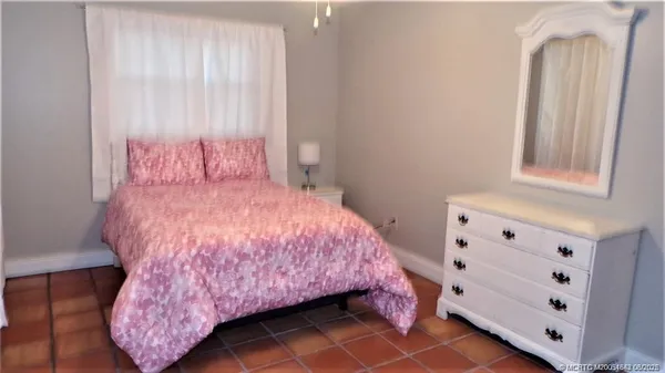 a bedroom with a bed and a dresser