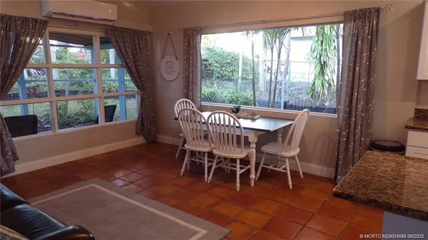 a view of a dining room with furniture window and outside view