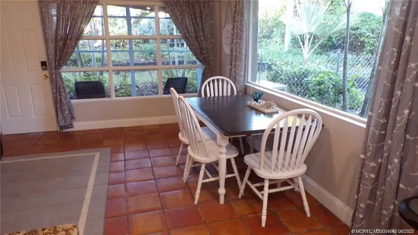 a view of a chairs and table in the balcony