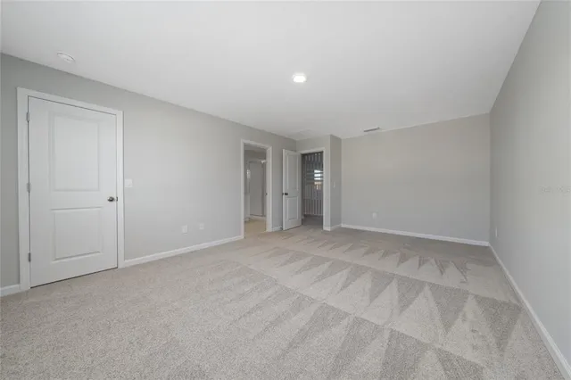 a spacious bathroom with a granite countertop sink mirror and a