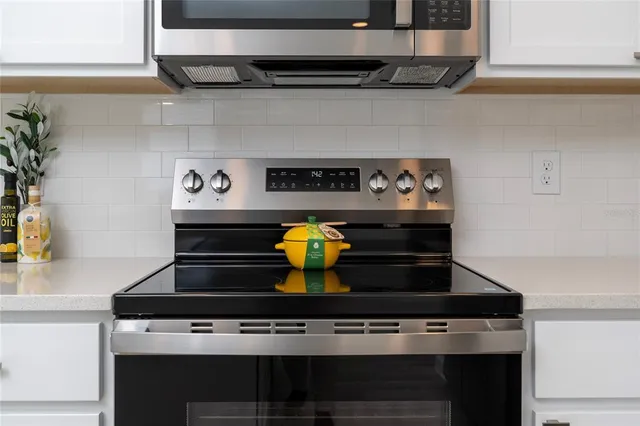 a kitchen with a sink cabinets and wooden floor