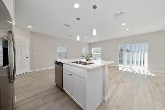 a kitchen with a sink stainless steel appliances and cabinets