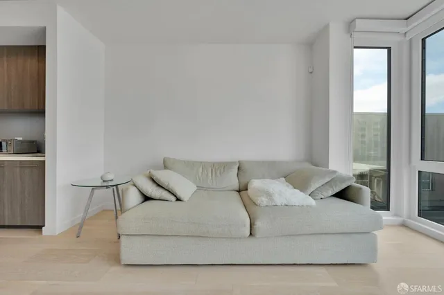 a living room with furniture and large windows