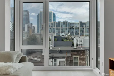 a living room with furniture and a floor to ceiling window