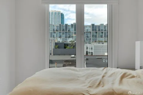 a bedroom with a bed and glass window