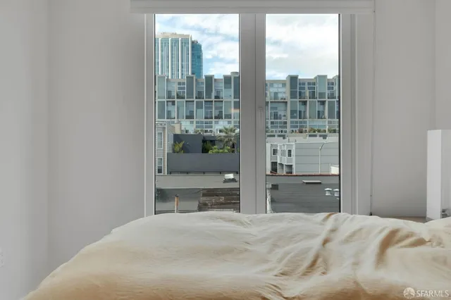 a bedroom with a bed and glass window