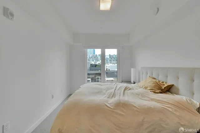 a bedroom with a bed and window