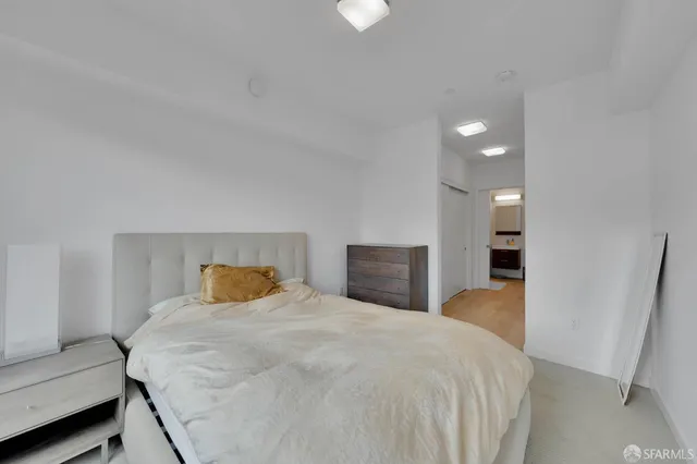 a bedroom with a bed and a couch