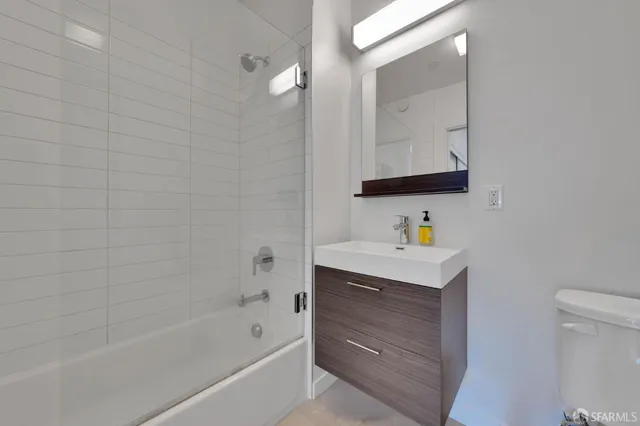 a bathroom with a bathtub sink vanity and mirror