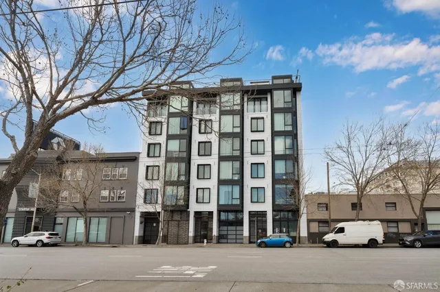 a front view of a building with a garden