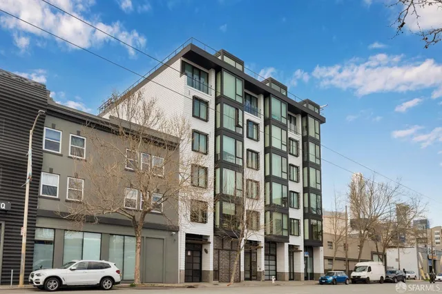 a front view of a residential apartment building with a yard
