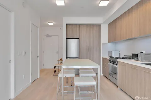 a kitchen with a stove a sink and a refrigerator